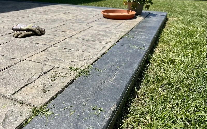 Detail of a contrasting color band around a stamped patio edge