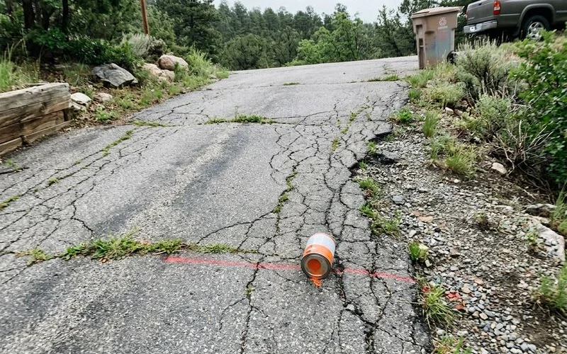 The original cracked asphalt driveway before demolition