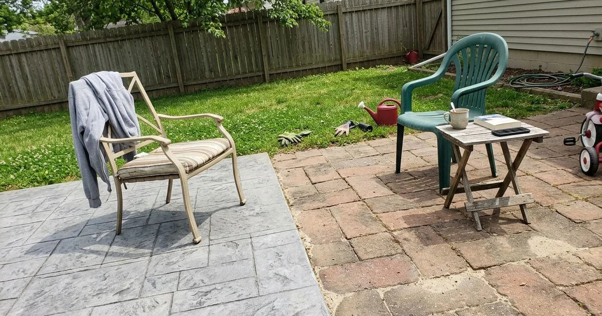 Split view of a stamped concrete patio and a paver patio side by side